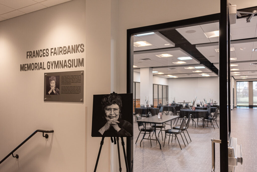 A painting of Frances Fairbanks on display outside a dining hall.