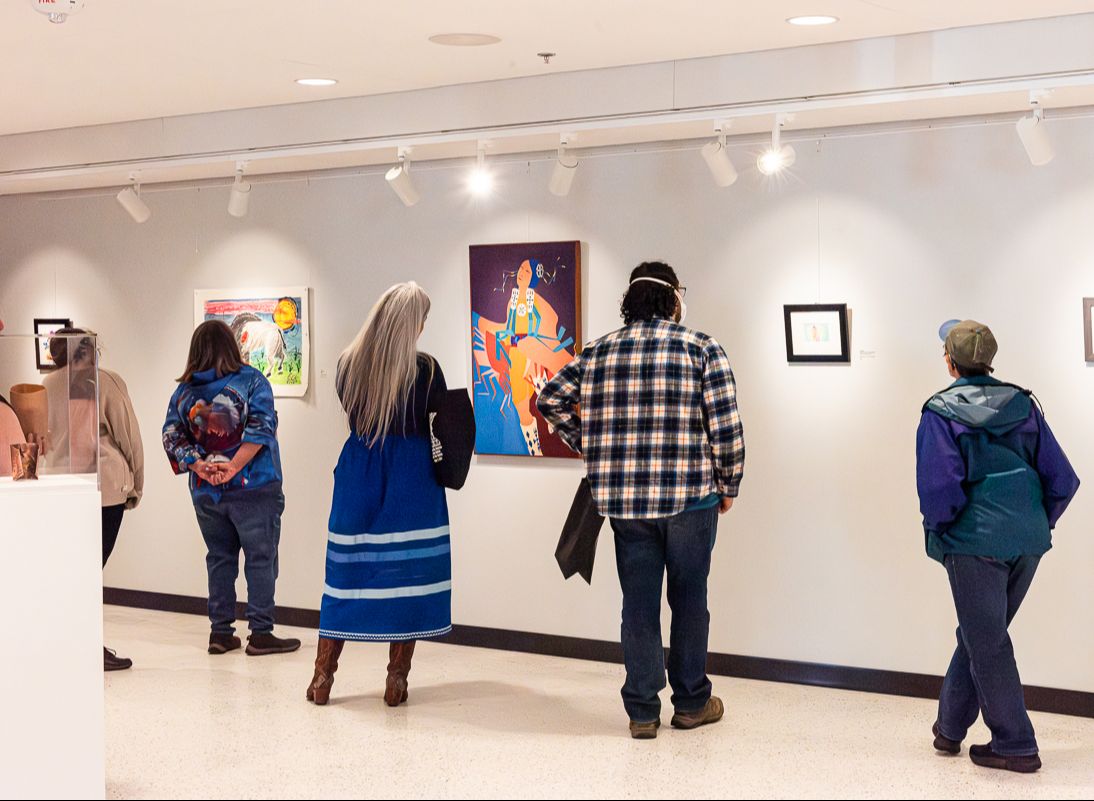 Visitors view art on display at the Two Rivers Art Gallery grand reopening on May 1, 2024.