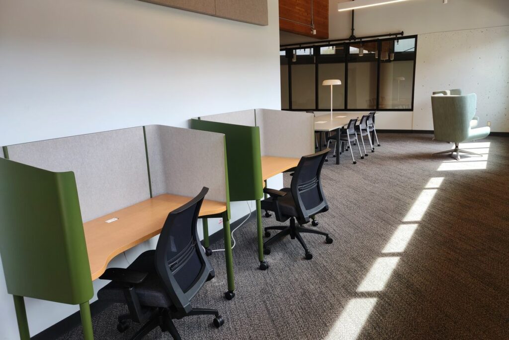 A row of desks and office chairs.