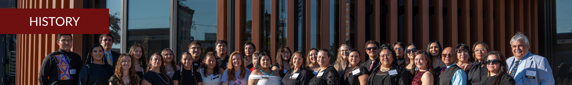 A photo of the Minneapolis American Indian Center staff in front of the center building.